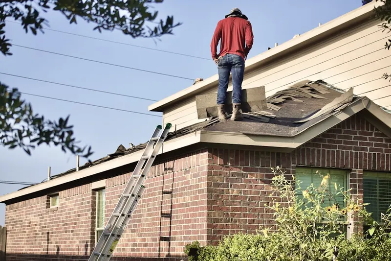 Professional roofer working on a residential roof in North Asheboro